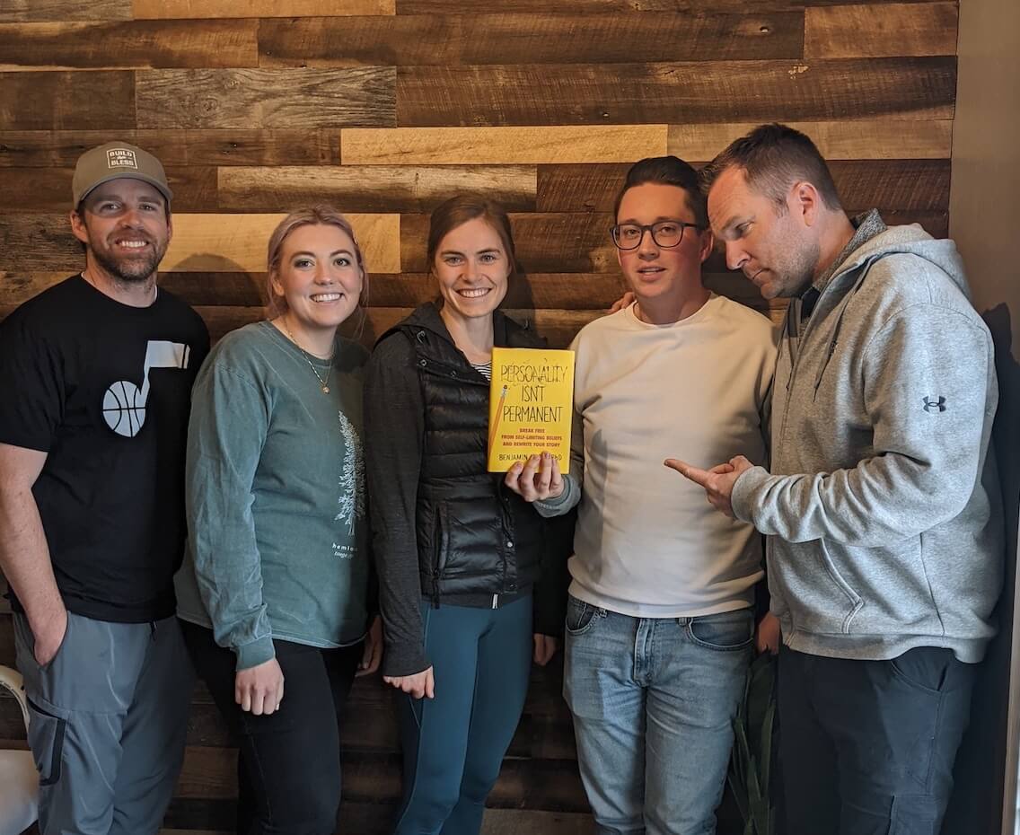 Lemonade Stand company book club - five members of the team hold the book Personality Isn't Permanent