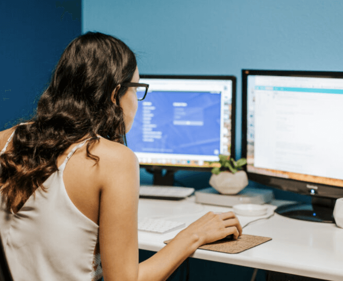 girl sits in front of computer at desk - intro to digital marketing services from lemonade stand