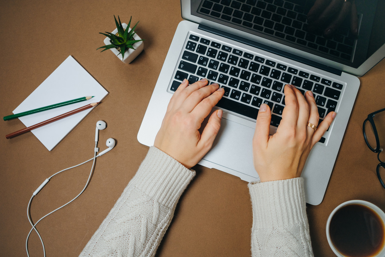 Woman writing on a laptop